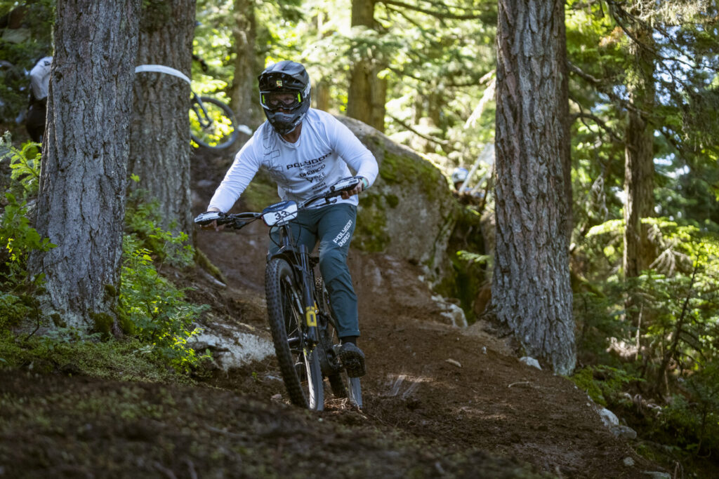 Mountain biker descending trail near Michlifen with forest backdrop