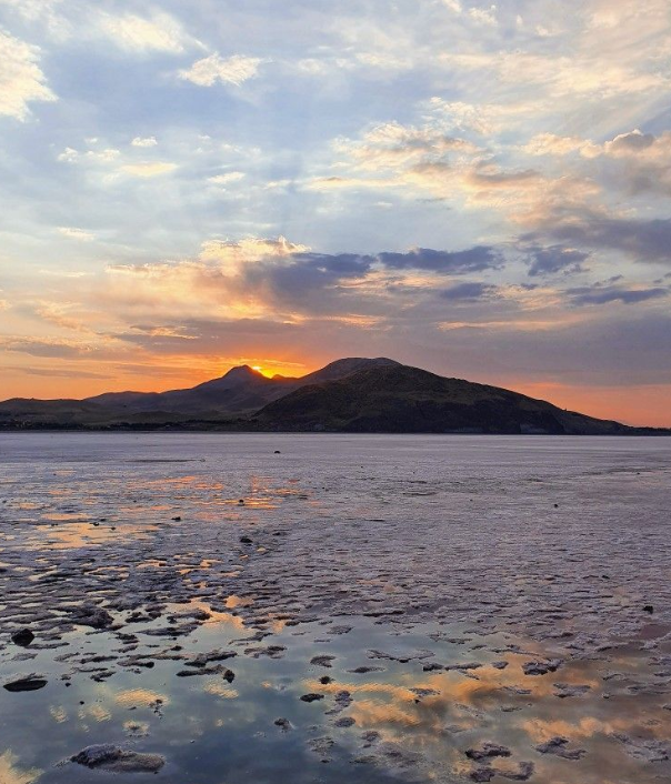3-Day Itinerary in Ifrane water of Dayet Aoua Lake reflecting blue skies and surrounding pine trees, creating a mirror-like natural landscape.which perfact for Ifrane solo female traveler